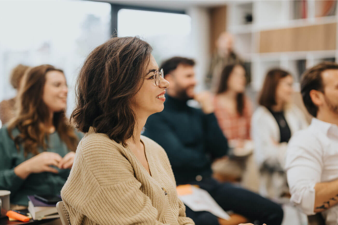 Participants engaged and smiling during a GrowWerk keynote or team training event.