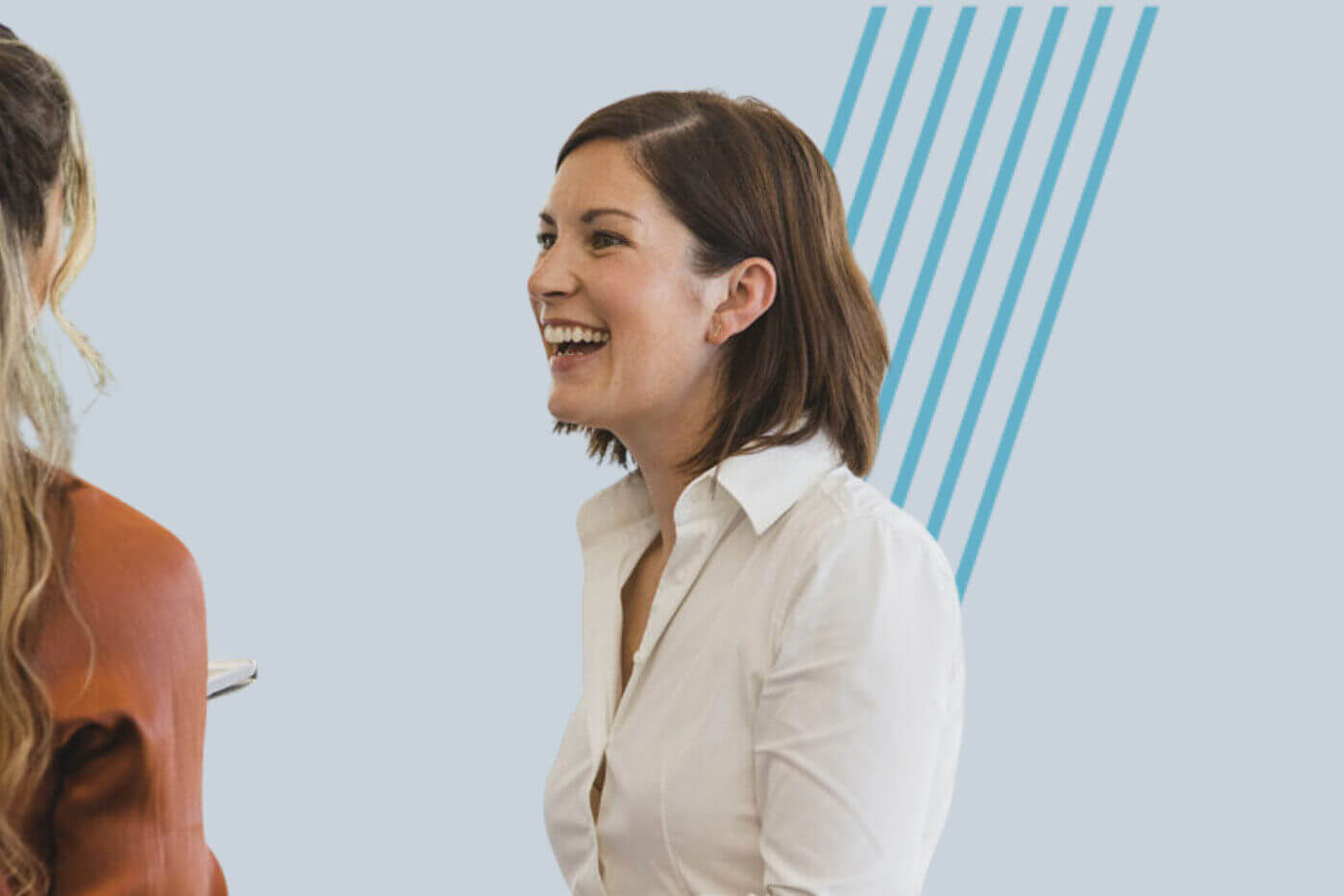 Two colleagues in conversation during a team workshop, focusing on listening and communication.