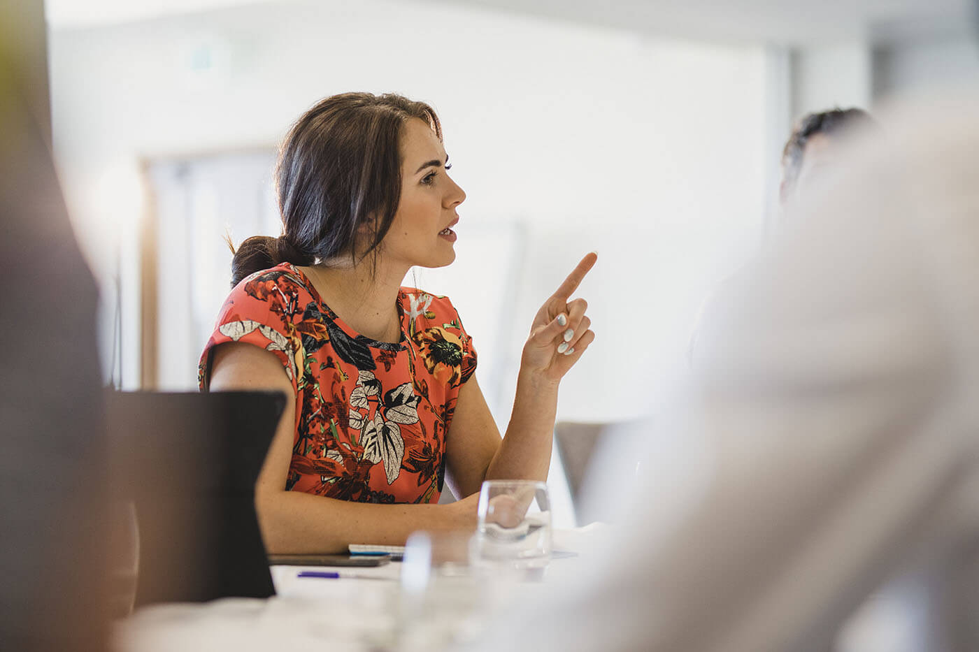 Professional woman speaking and sharing ideas during a discussion in a workshop.